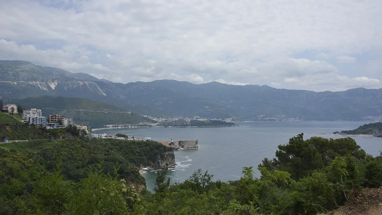 Budva Old Town on its peninsula, the Riviera bay and hotel strip stretching toward Bečići