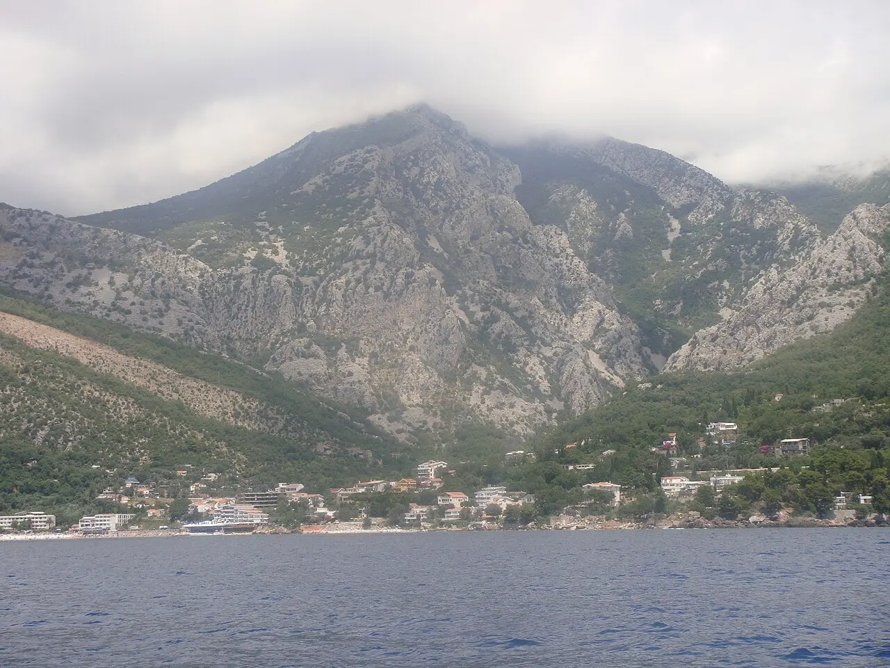 The Bar and Sutomore coastline seen from the sea, with mountains rising behind the shore