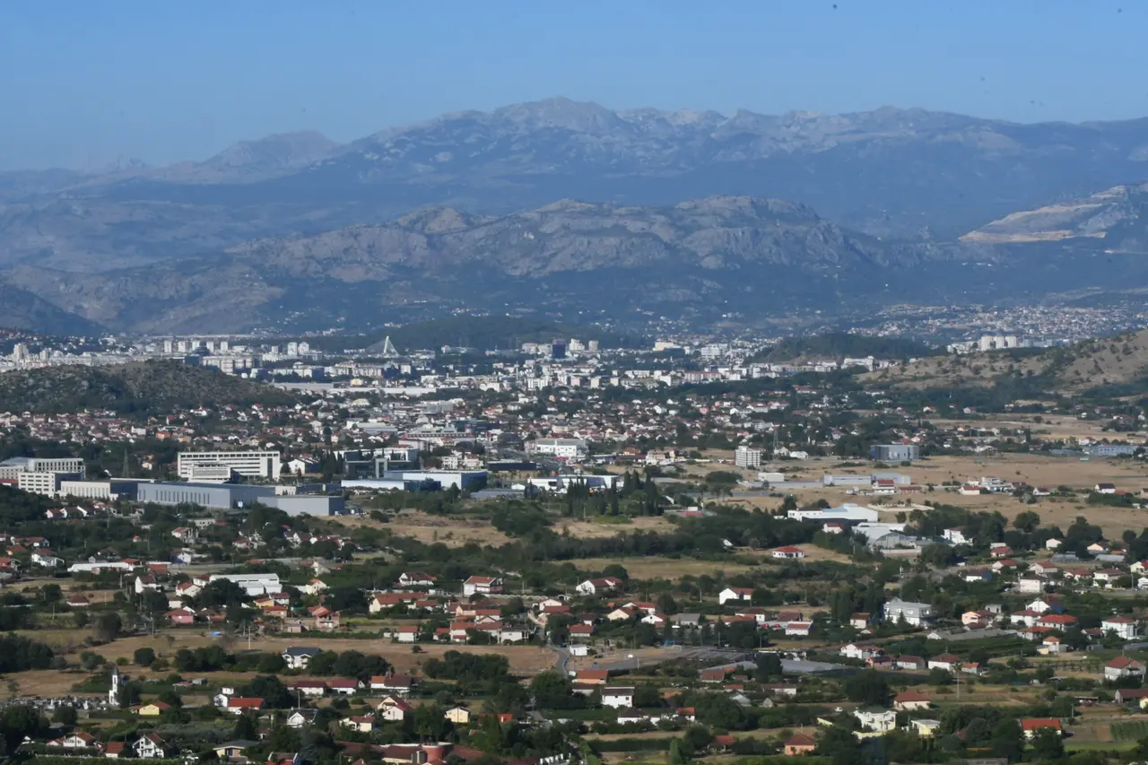 Wide view over Podgorica in its basin with mountains behind, Montenegro