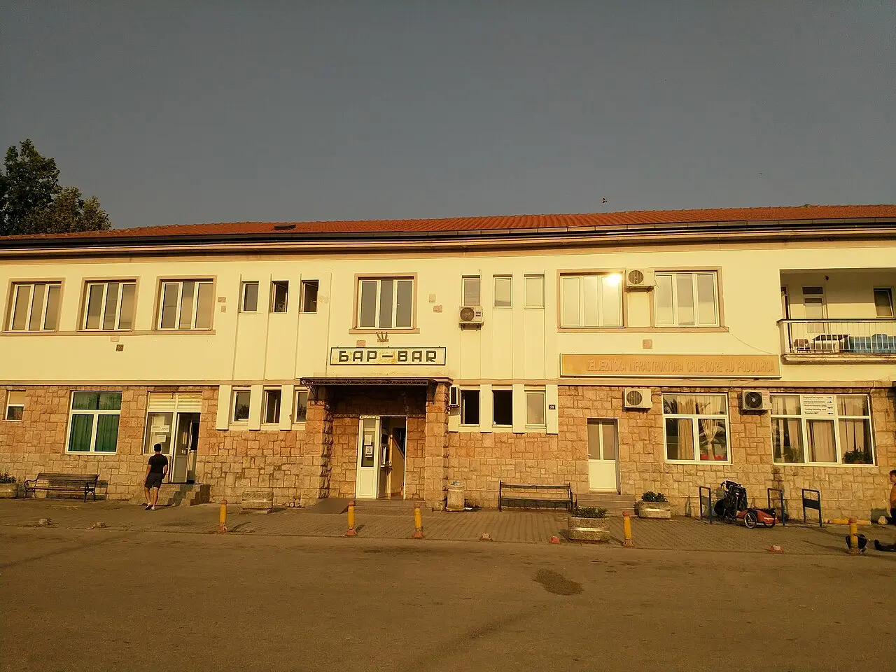 The single-storey railway station building at Bar with the BAR sign in Cyrillic and Latin