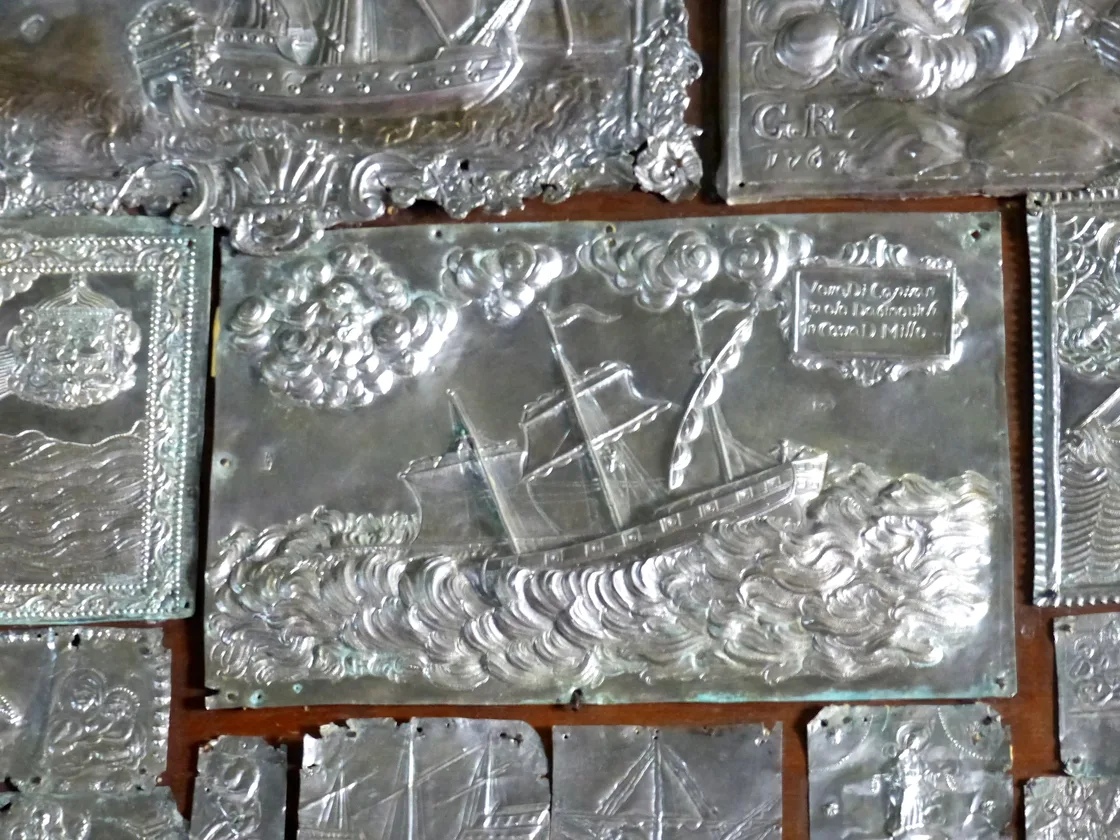 Silver votive plaques and Baroque paintings inside the church museum of Our Lady of the Rocks