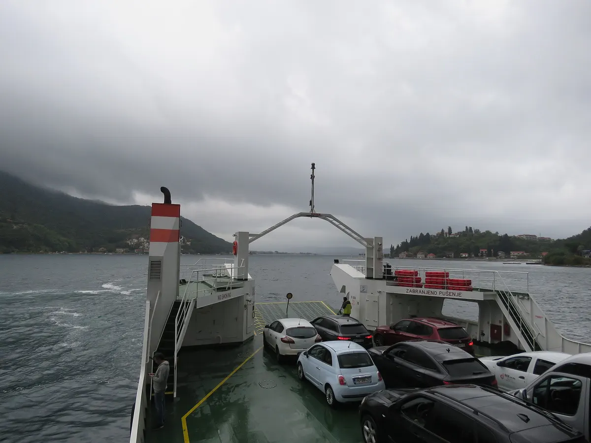 Cars loaded on the deck of the Kamenari to Lepetane car ferry mid-crossing the Bay of Kotor