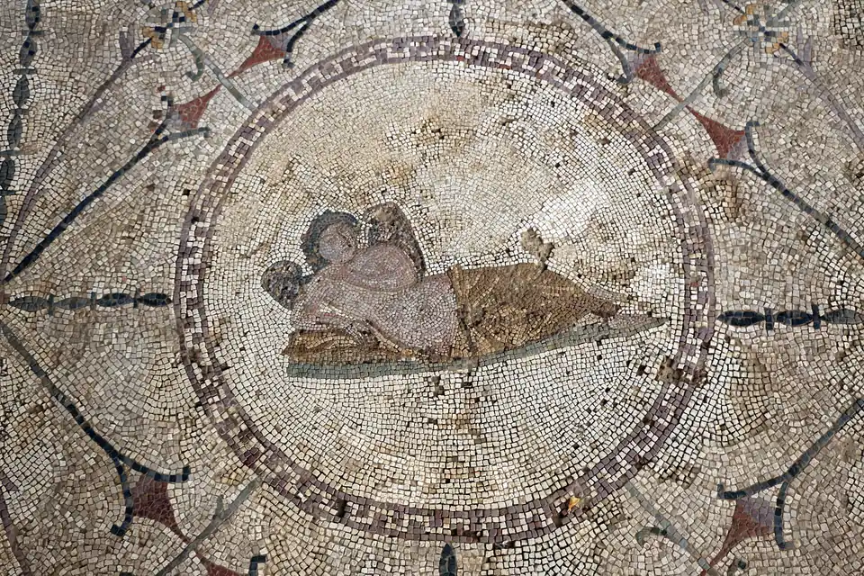 The Roman floor mosaic of Hypnos, the winged god of sleep reclining inside a circular medallion, at Risan