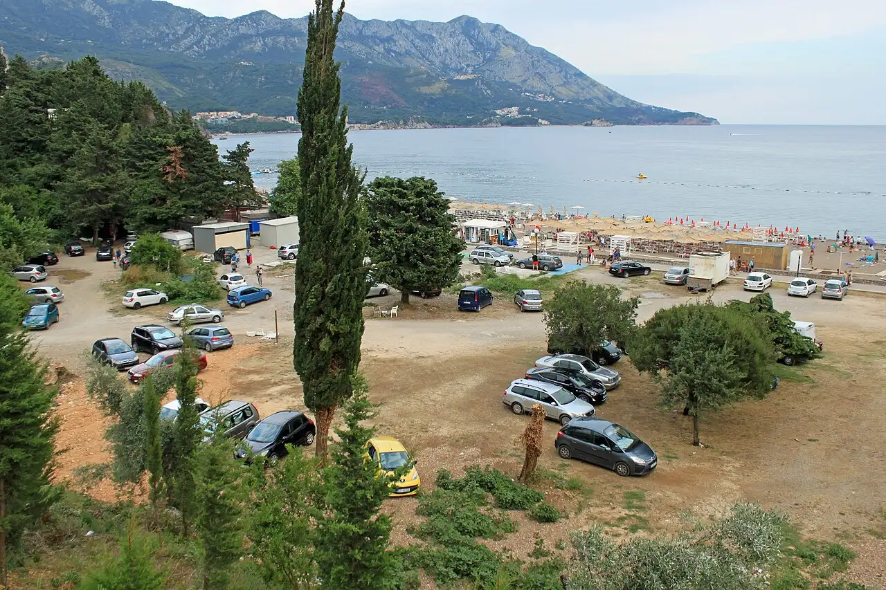 Access road and parking area above Bečići beach with the sea beyond