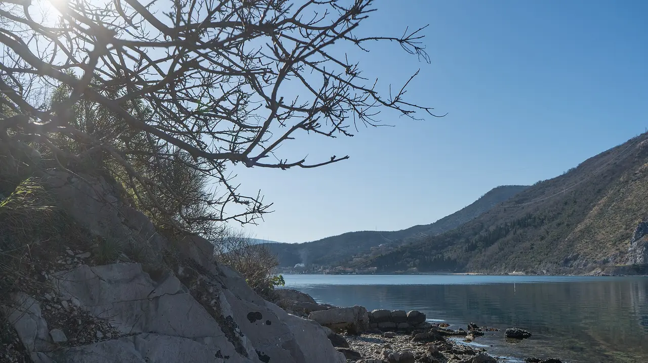 Panoramic view over the Bay of Kotor in Montenegro with mountains and calm water