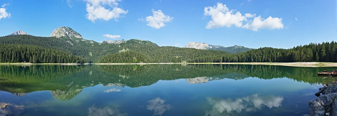The twin basins of Black Lake (Crno jezero) ringed by spruce forest in Durmitor National Park, Montenegro