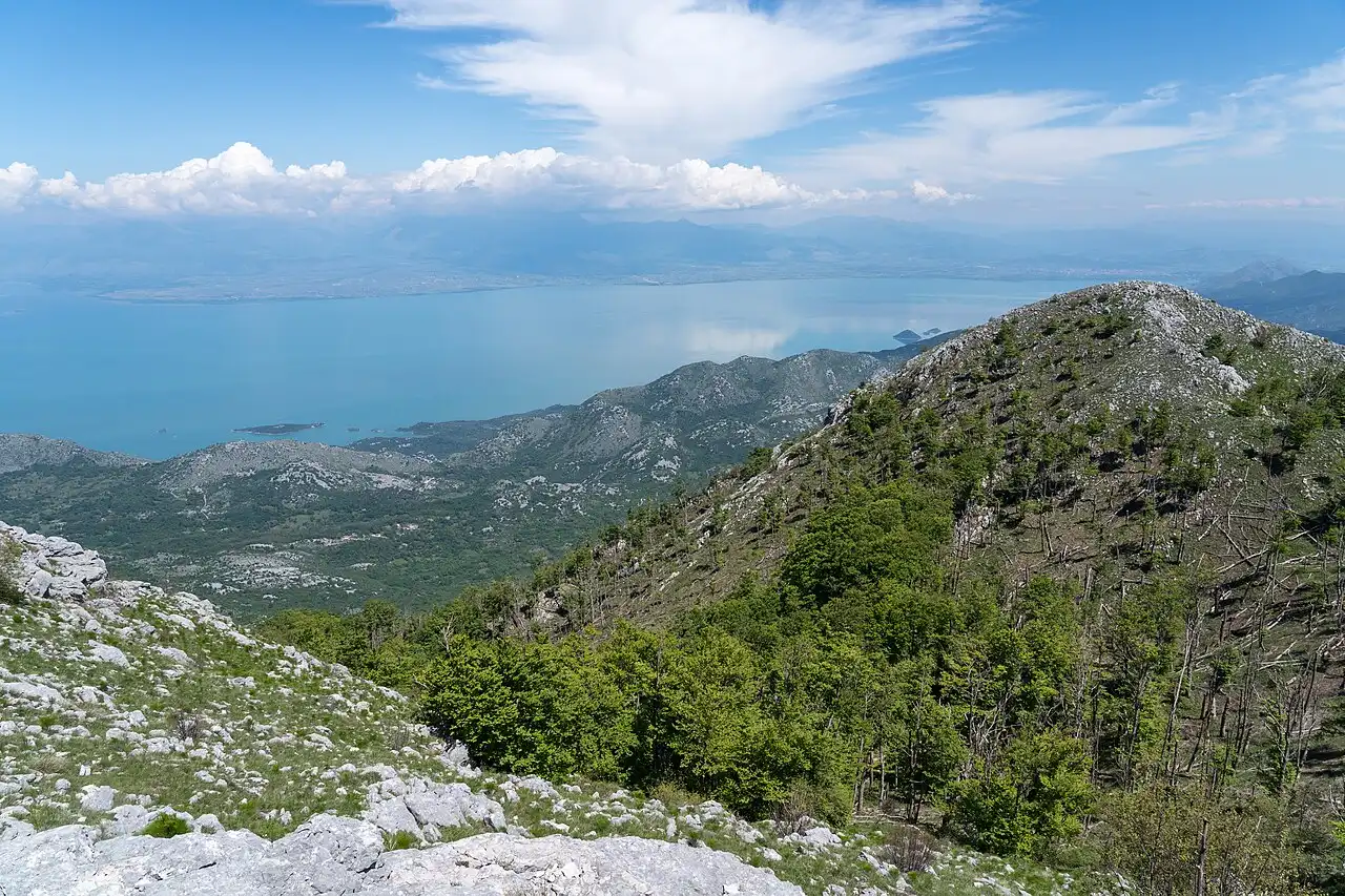 View from the hiking trail toward Rumija mountain with Lake Skadar and distant peaks, Montenegro