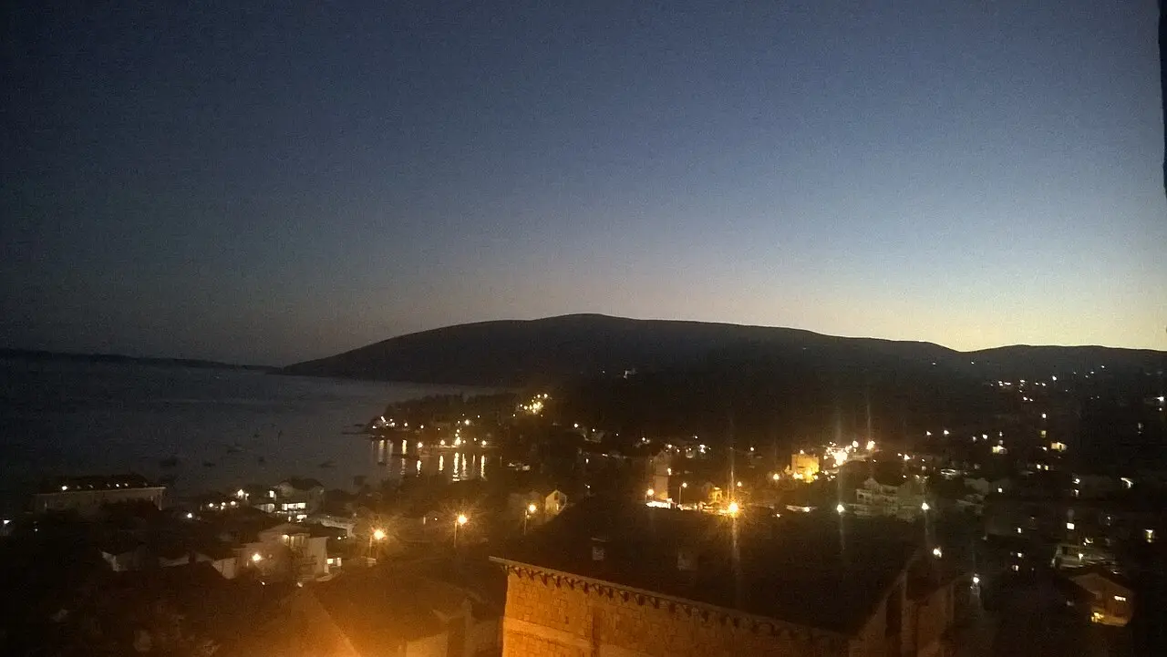 Wide view of Meljine on the Bay of Kotor with hills behind the shore