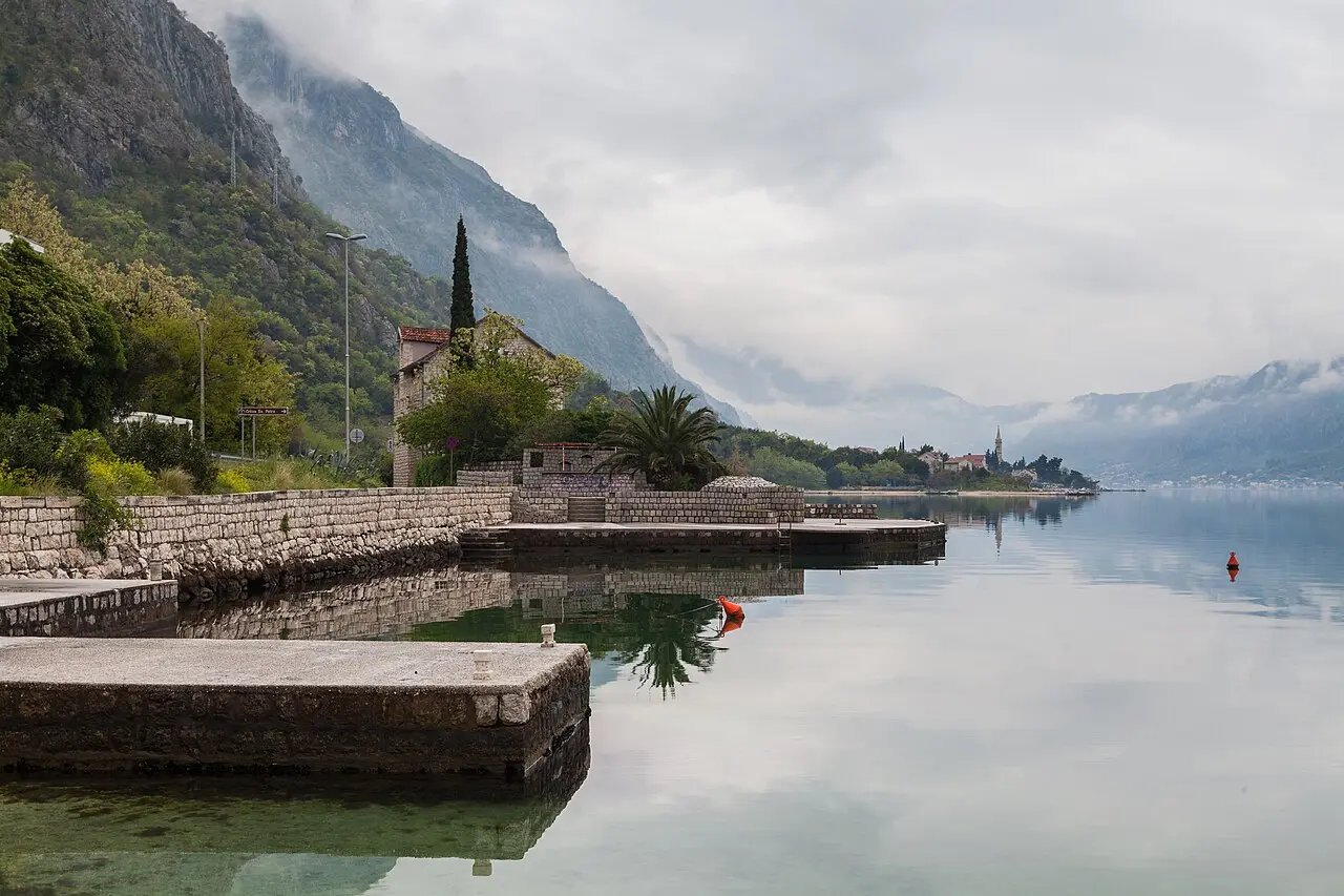 Calm water, stone quays and mountains at Ljuta on the Bay of Kotor