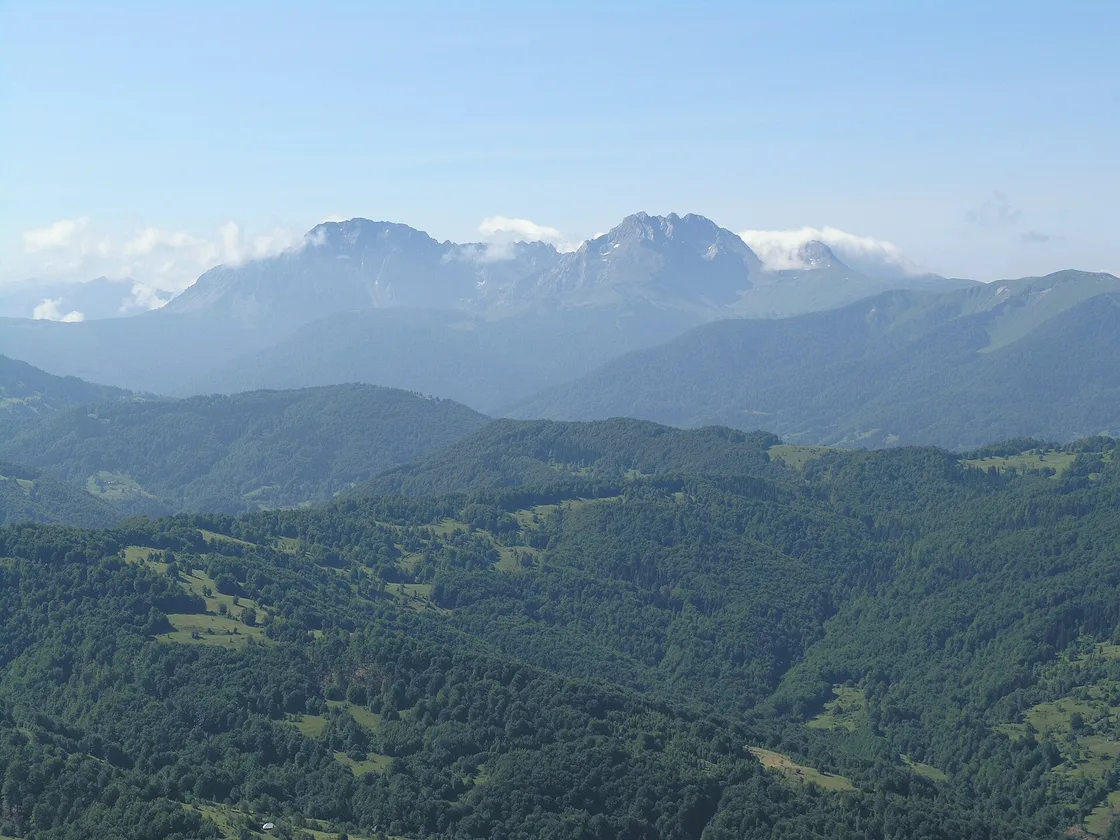 The rocky Komovi peaks rising above the forested hills of Bjelasica in northern Montenegro