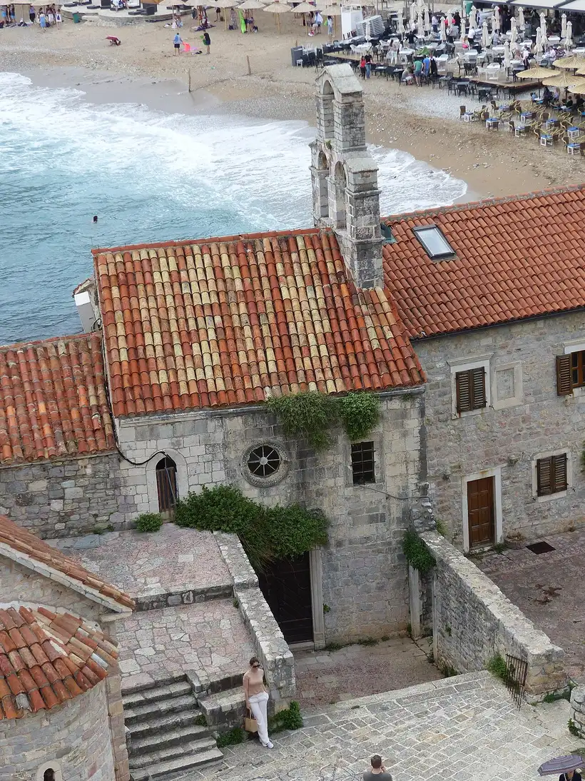The stone Santa Maria in Punta church with its red-tiled roof inside Budva Old Town