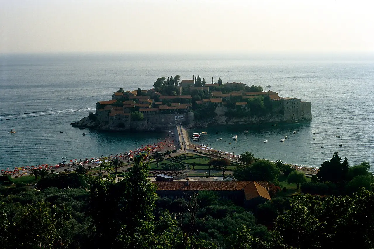 The island of Sveti Stefan with its stone houses joined to the shore by a causeway and beach