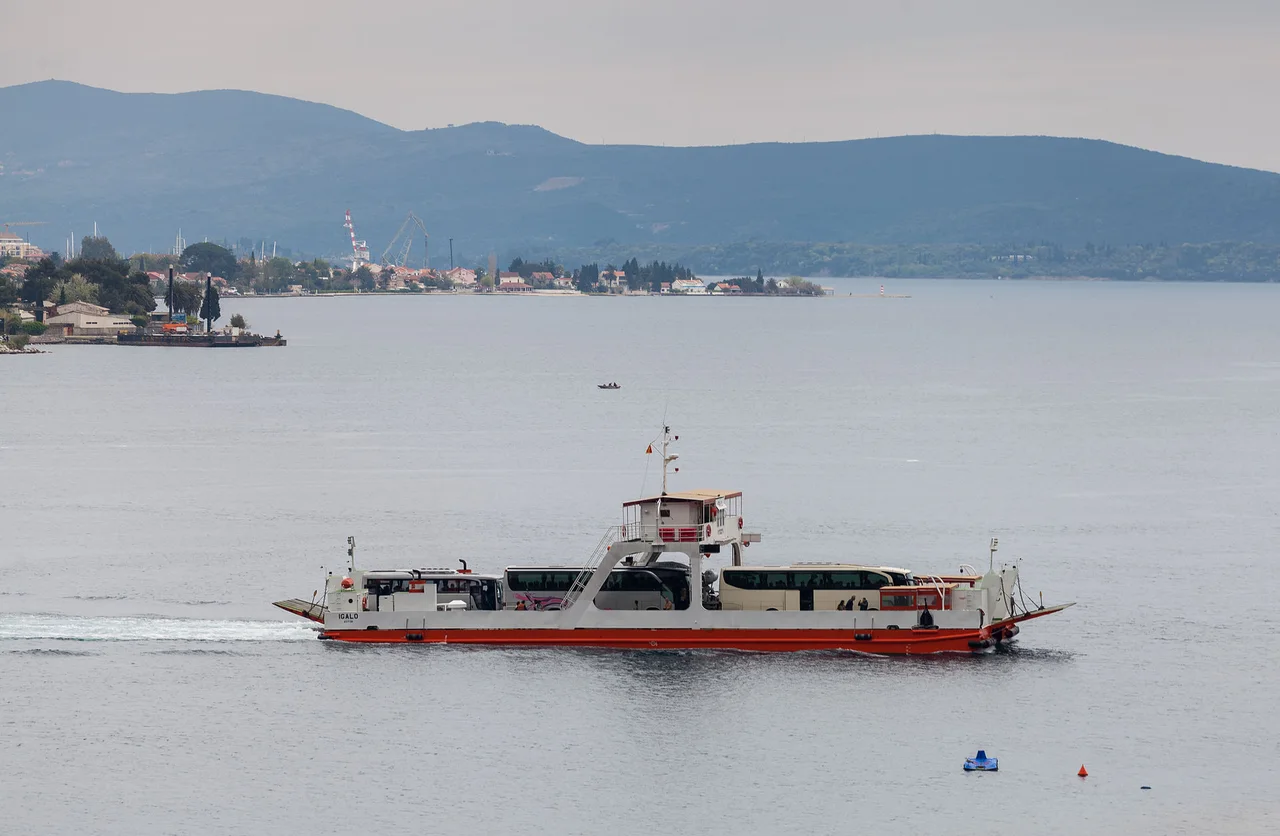 The Kamenari to Lepetane car ferry crossing the Bay of Kotor loaded with vehicles