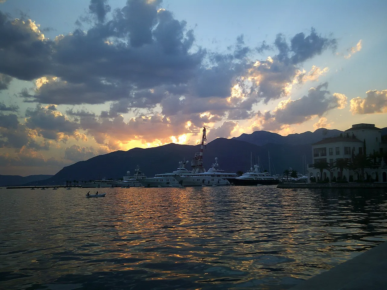Tivat waterfront and Porto Montenegro marina at sunset with yachts and mountains
