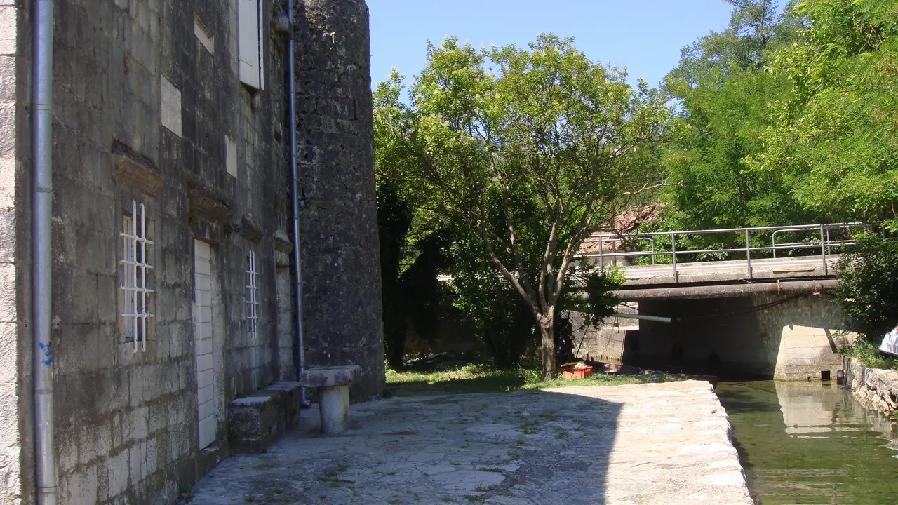 Old stone mill buildings by the stream in Morinj, Bay of Kotor