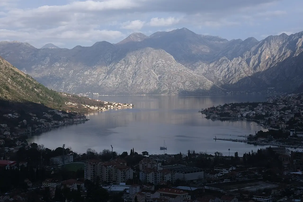 The inner Bay of Kotor with the town below and grey mountains rising on both shores