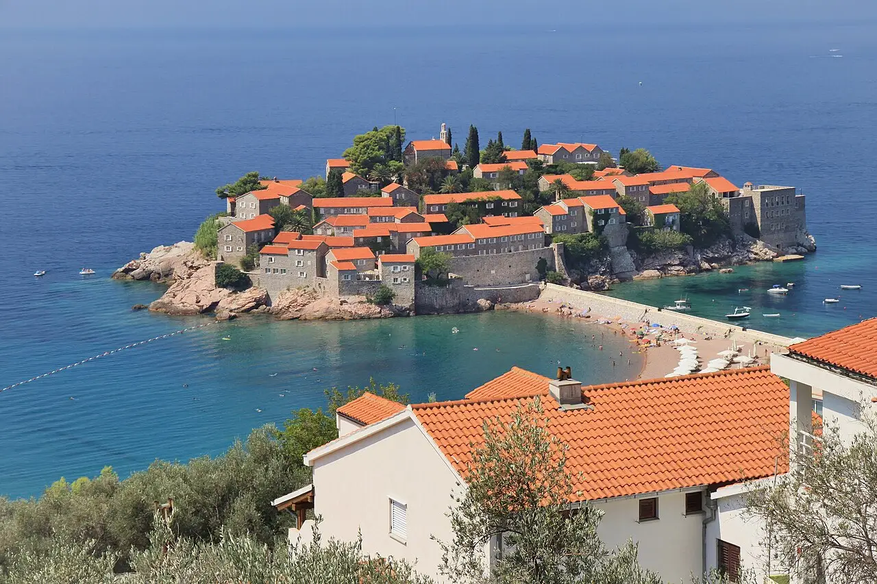 The islet of Sveti Stefan with its red-roofed stone houses and the beaches either side of the causeway