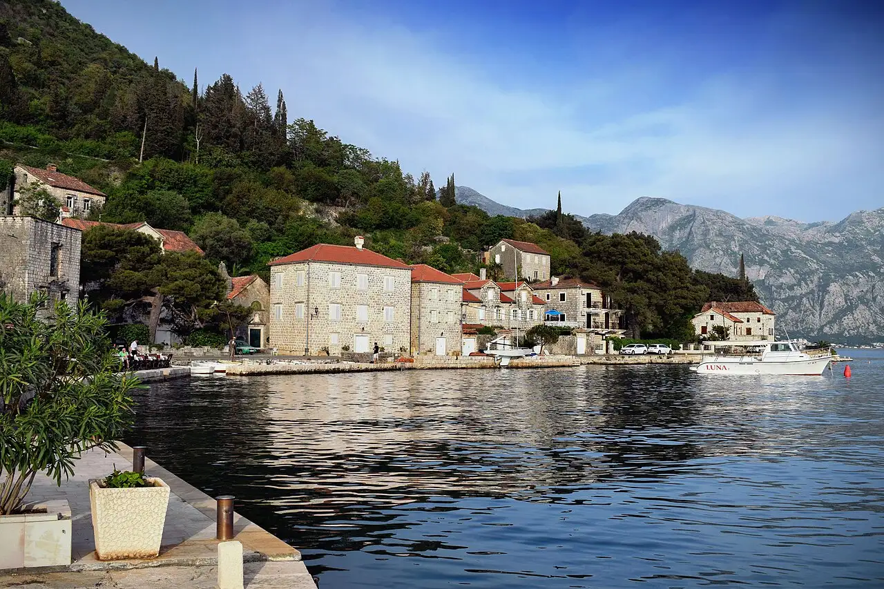 Stone waterfront houses of Perast along the Bay of Kotor in afternoon light