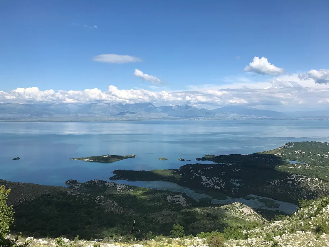 The green water and hills of Lake Skadar, the largest lake in the Balkans