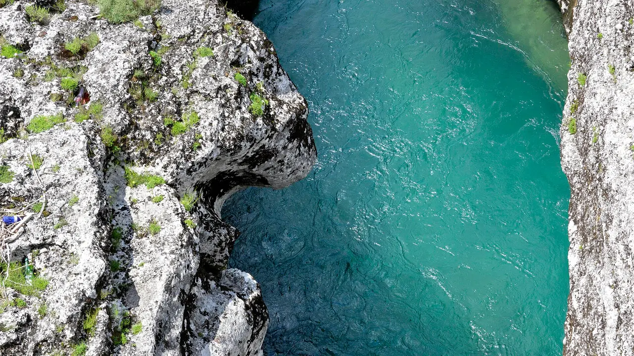 Looking down into a pale limestone chute of the Cijevna river east of Podgorica, turquoise water below