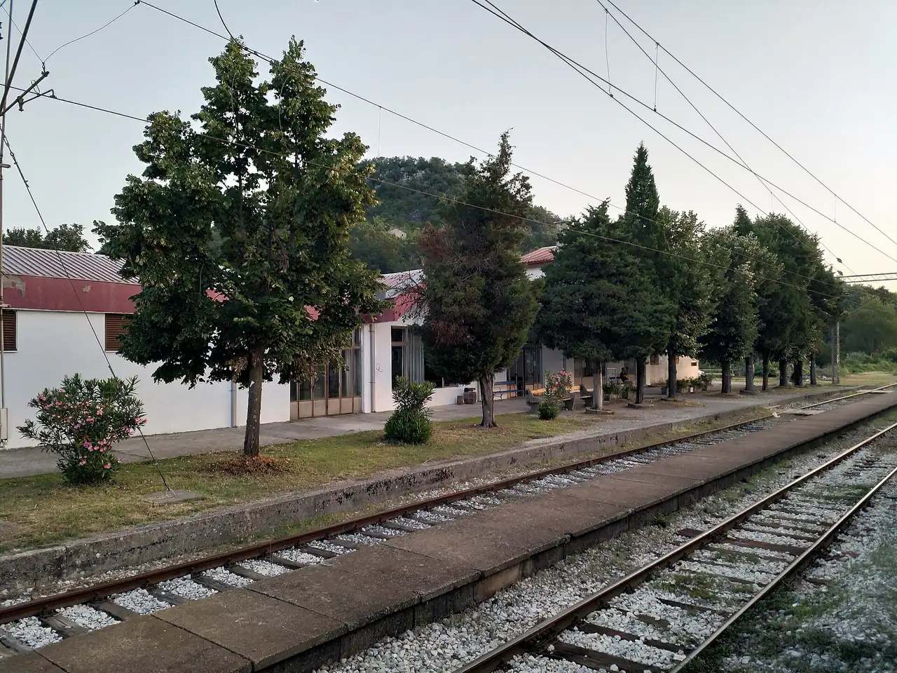 Virpazar railway halt on the Podgorica to Bar line, a low platform and station building in the hills above the lake