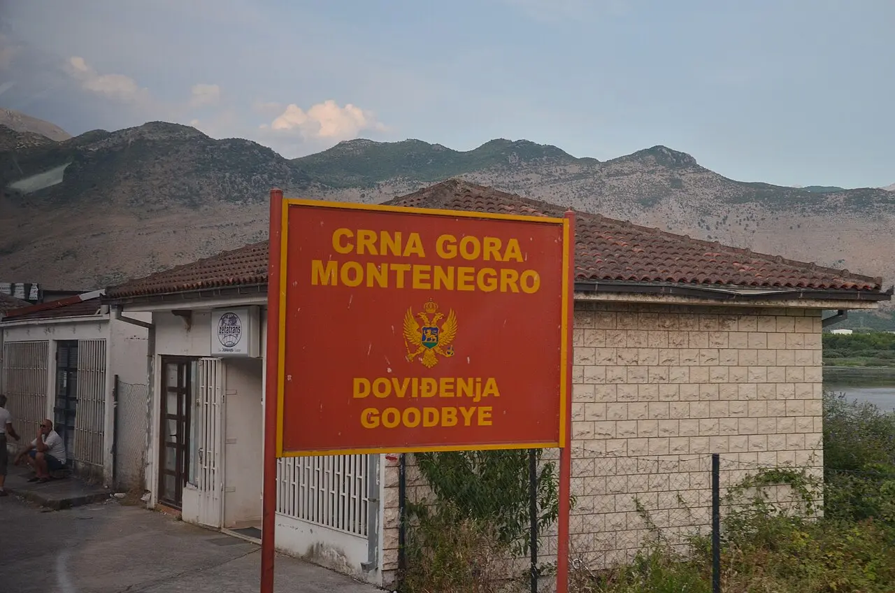 Road signs and barriers at the Božaj / Hani i Hotit border crossing between Montenegro and Albania
