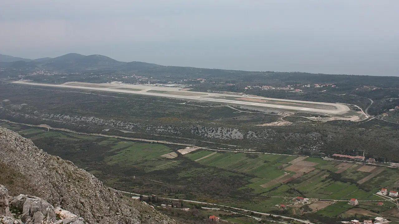 Terminal and apron at Dubrovnik Airport with the Adriatic hills beyond