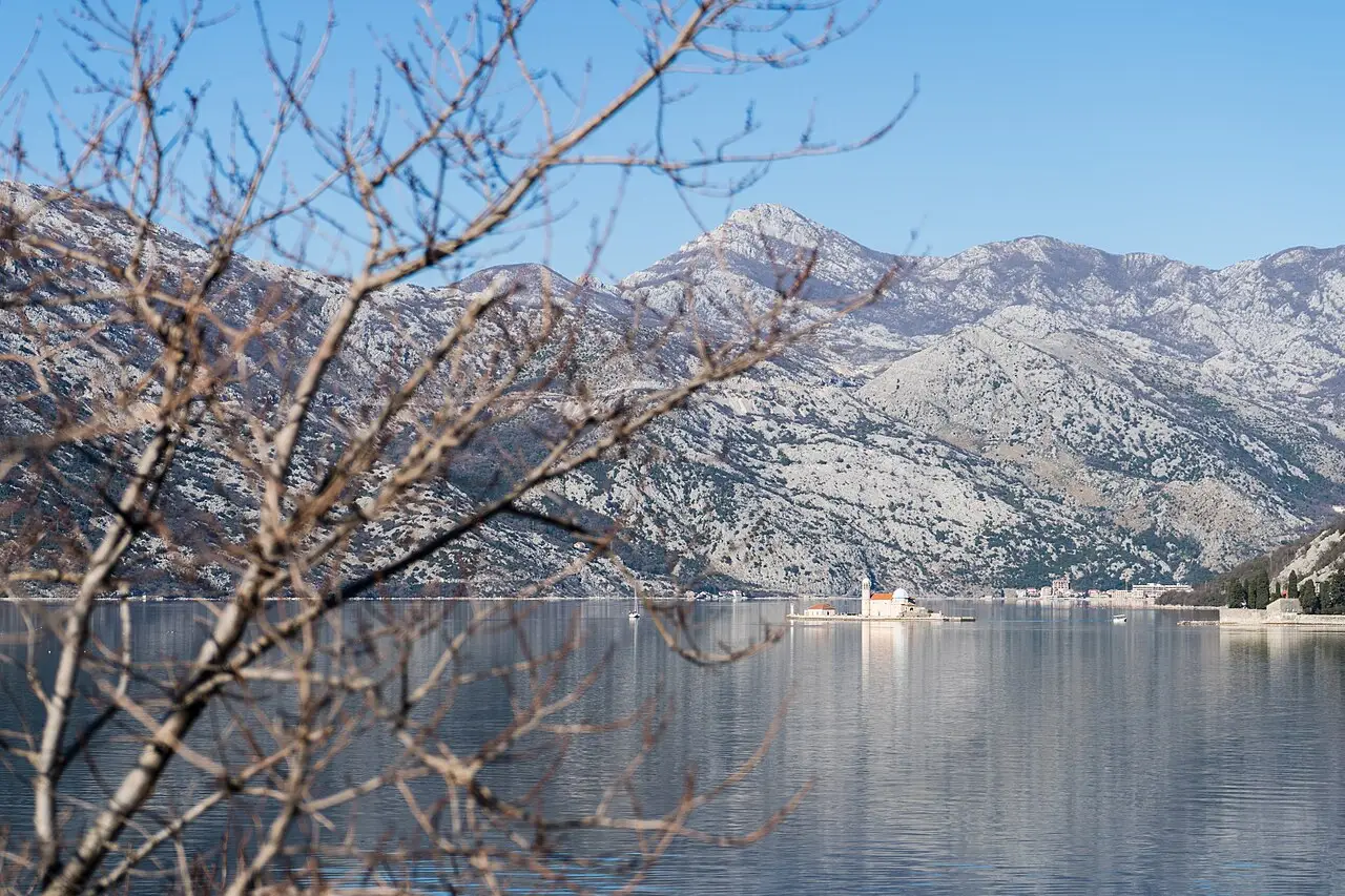 Our Lady of the Rocks islet seen across the winter waters of the Bay of Kotor from Lepetani, Montenegro