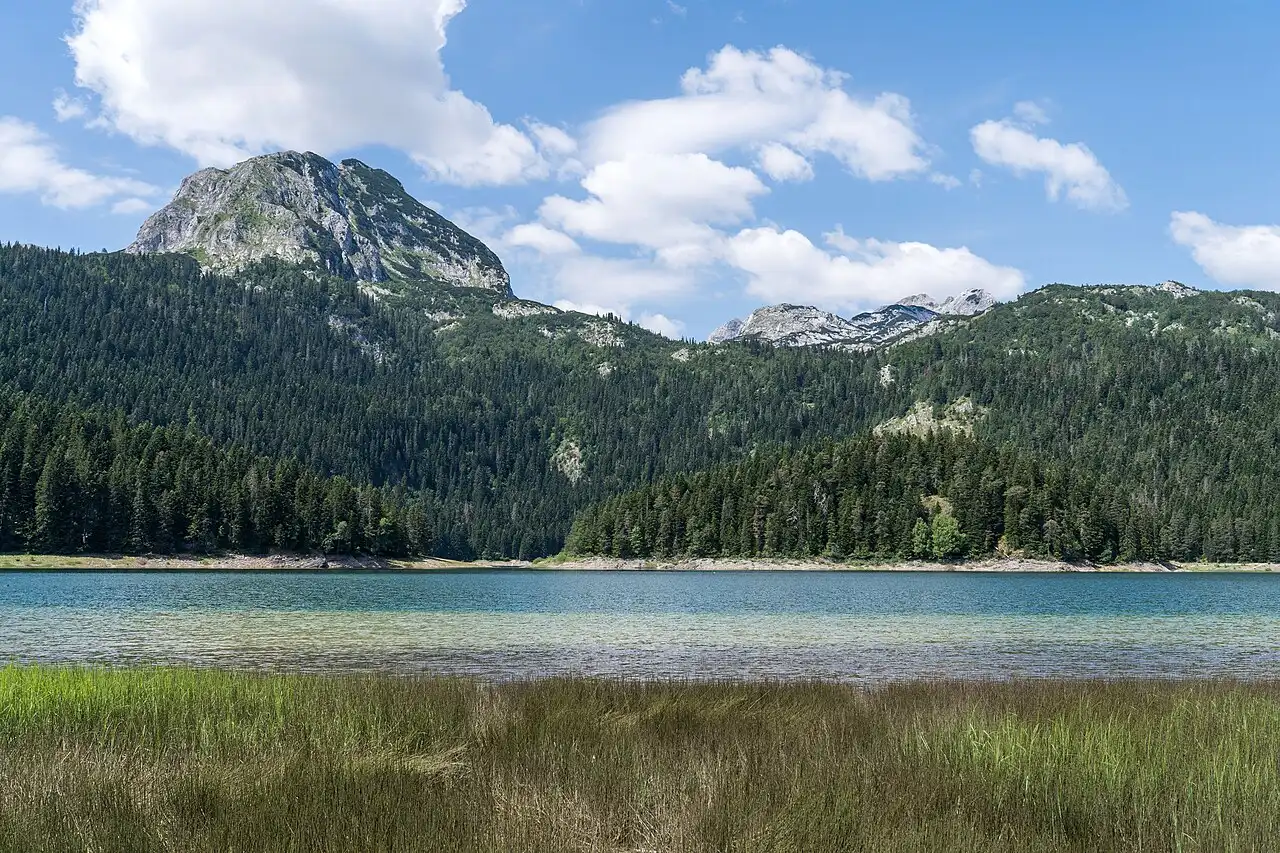 The Black Lake in Durmitor National Park with the peak of Meded reflected in still turquoise water