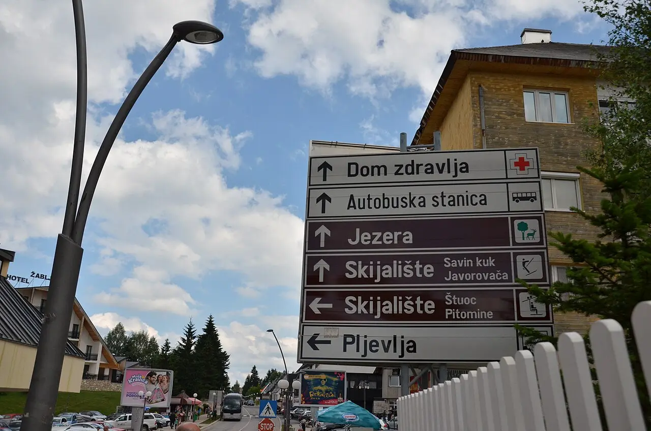 Brown road signs in Žabljak pointing to Jezera, the ski lifts at Savin Kuk and Pljevlja