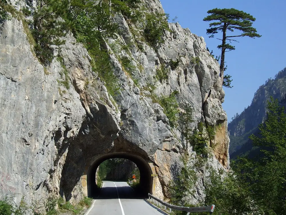 A road tunnel cut through bare rock in the Tara Canyon, northern Montenegro