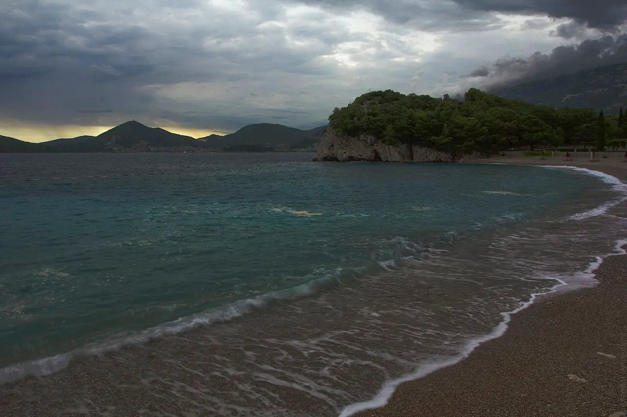 A quiet Adriatic cove and wooded headland near Budva at dusk, Montenegro