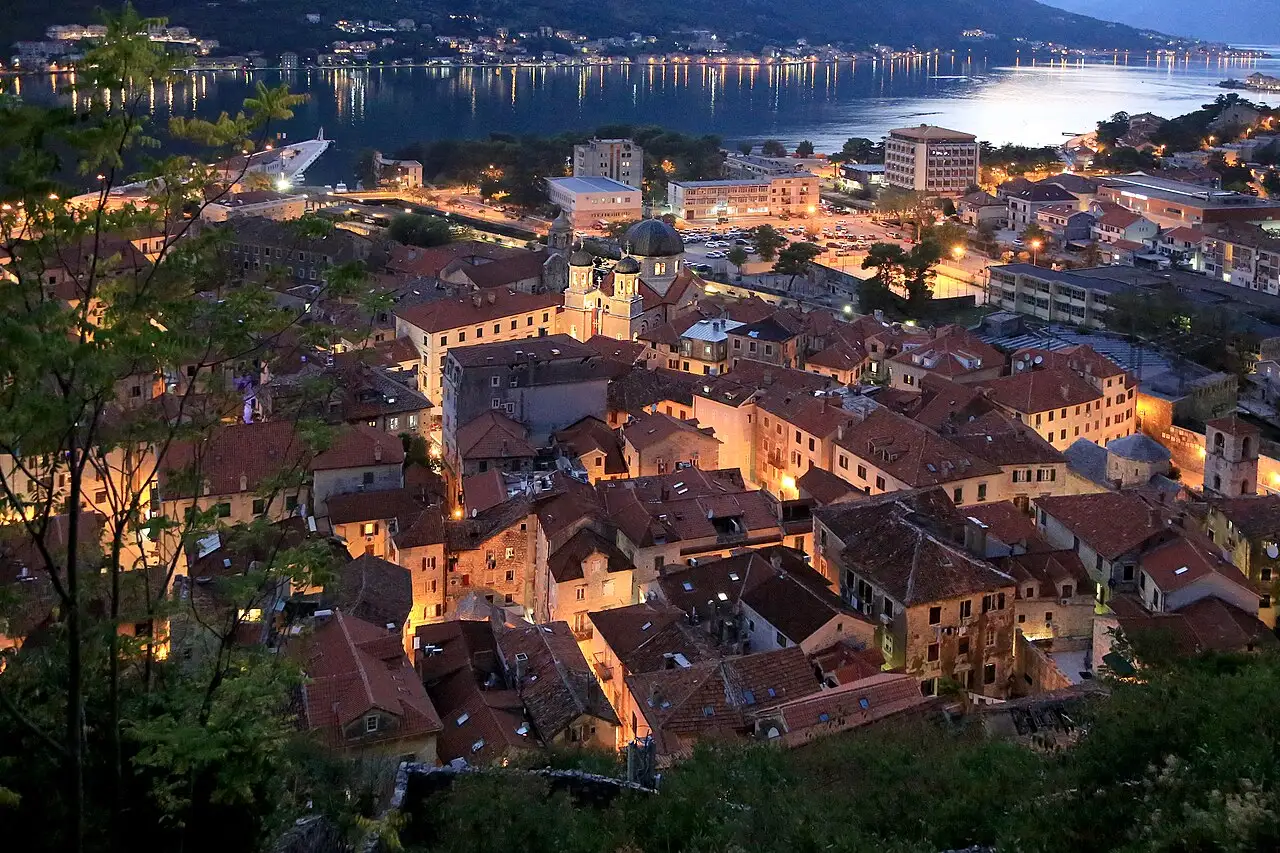 Kotor old town rooftops at dusk with the Bay of Kotor in the background, Montenegro