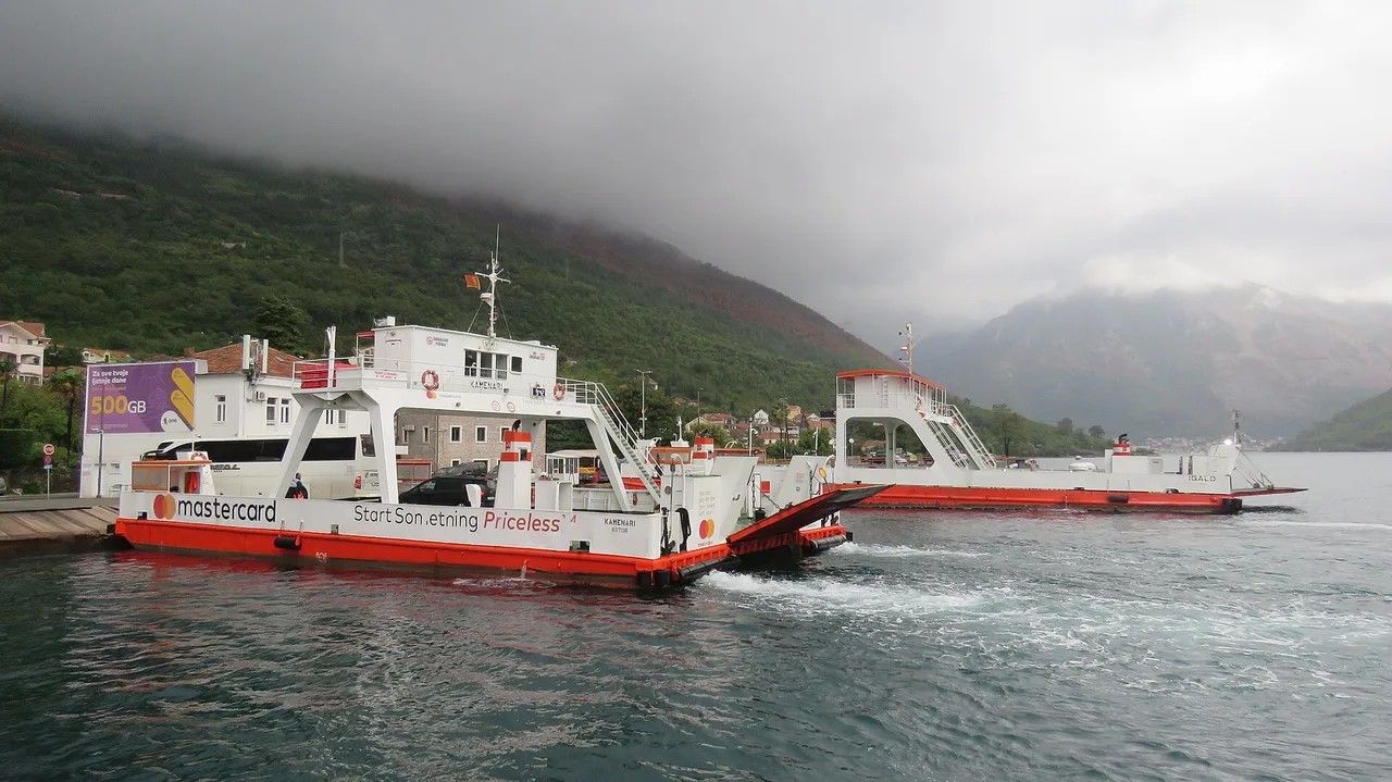 Two Kamenari-Lepetane ferries at the ramp on the Bay of Kotor, one with its bow ramp lowered