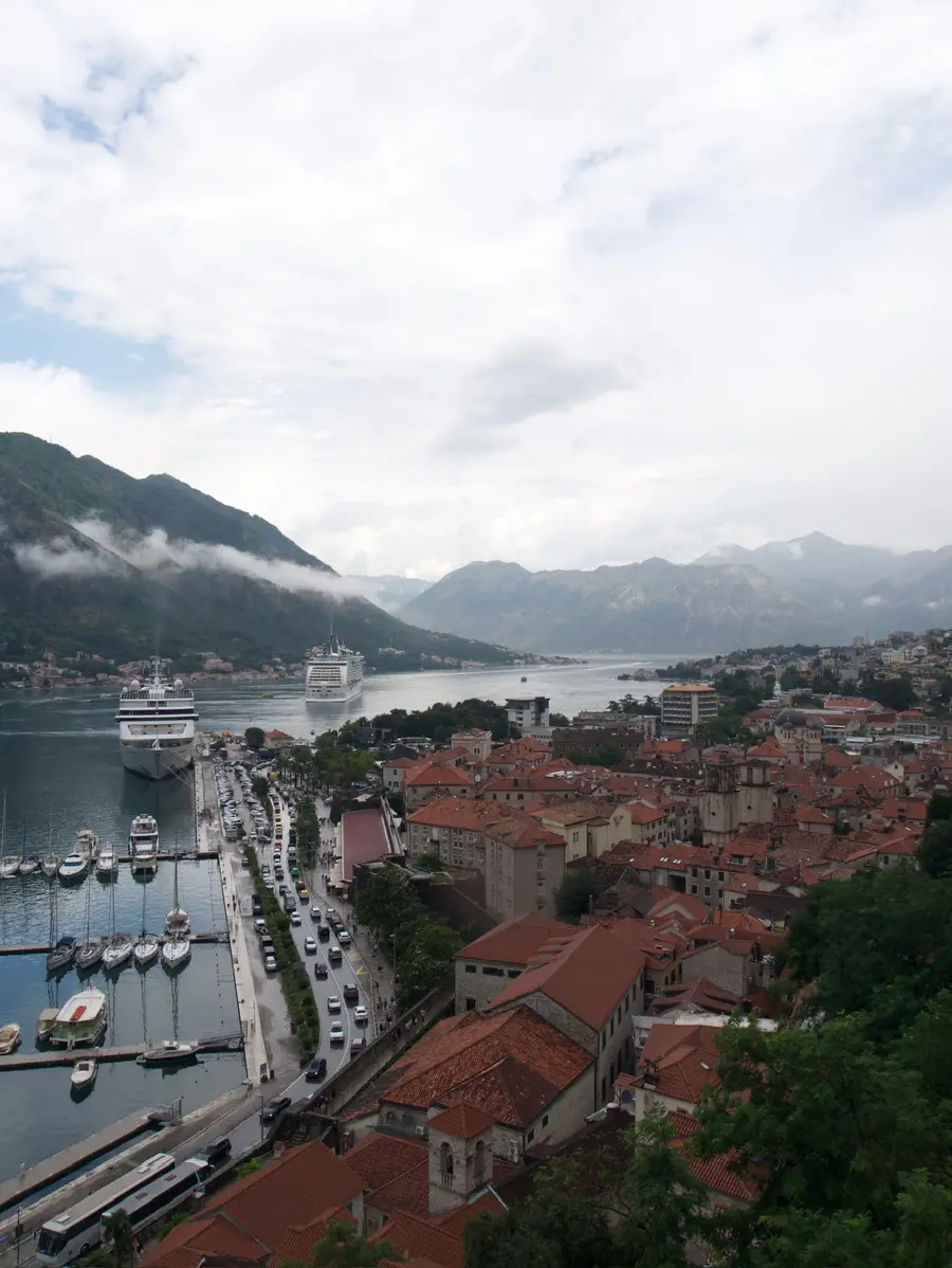 Two cruise ships at the Kotor waterfront seen from the city walls above the Old Town, Montenegro