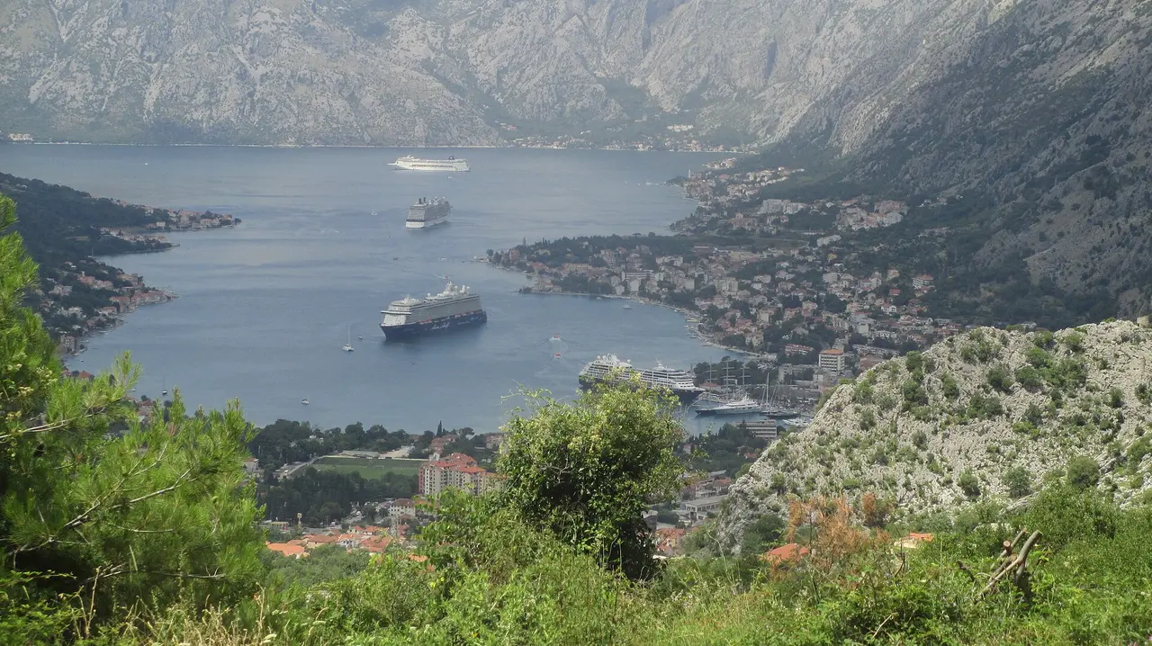 Four cruise ships in the inner Bay of Kotor, one alongside the pier and three at anchor, Montenegro
