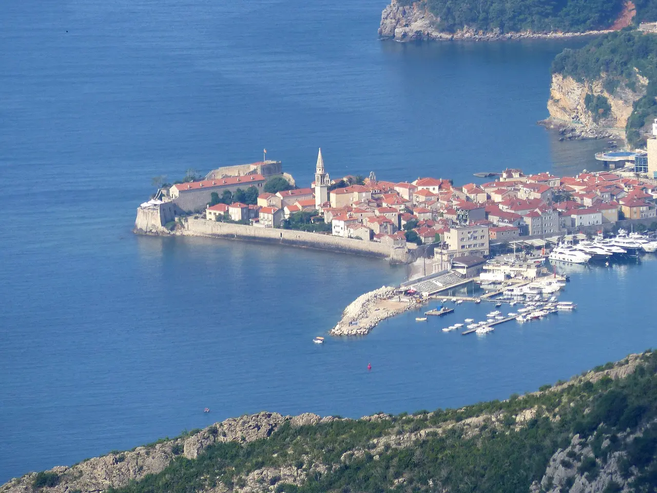 Aerial view of Budva Old Town on its small peninsula with the marina and red rooftops