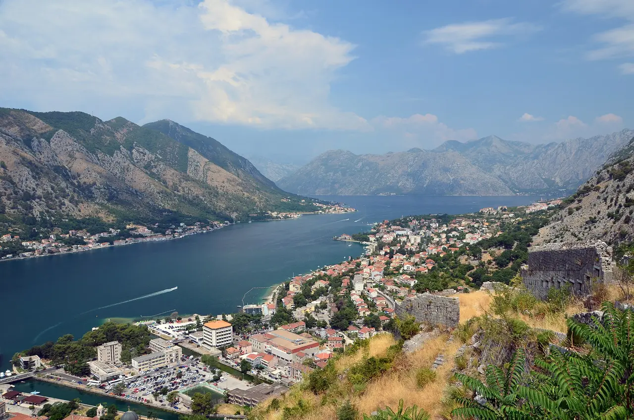 Sunny view over Kotor town and the long Bay of Kotor seen from the fortress walls above