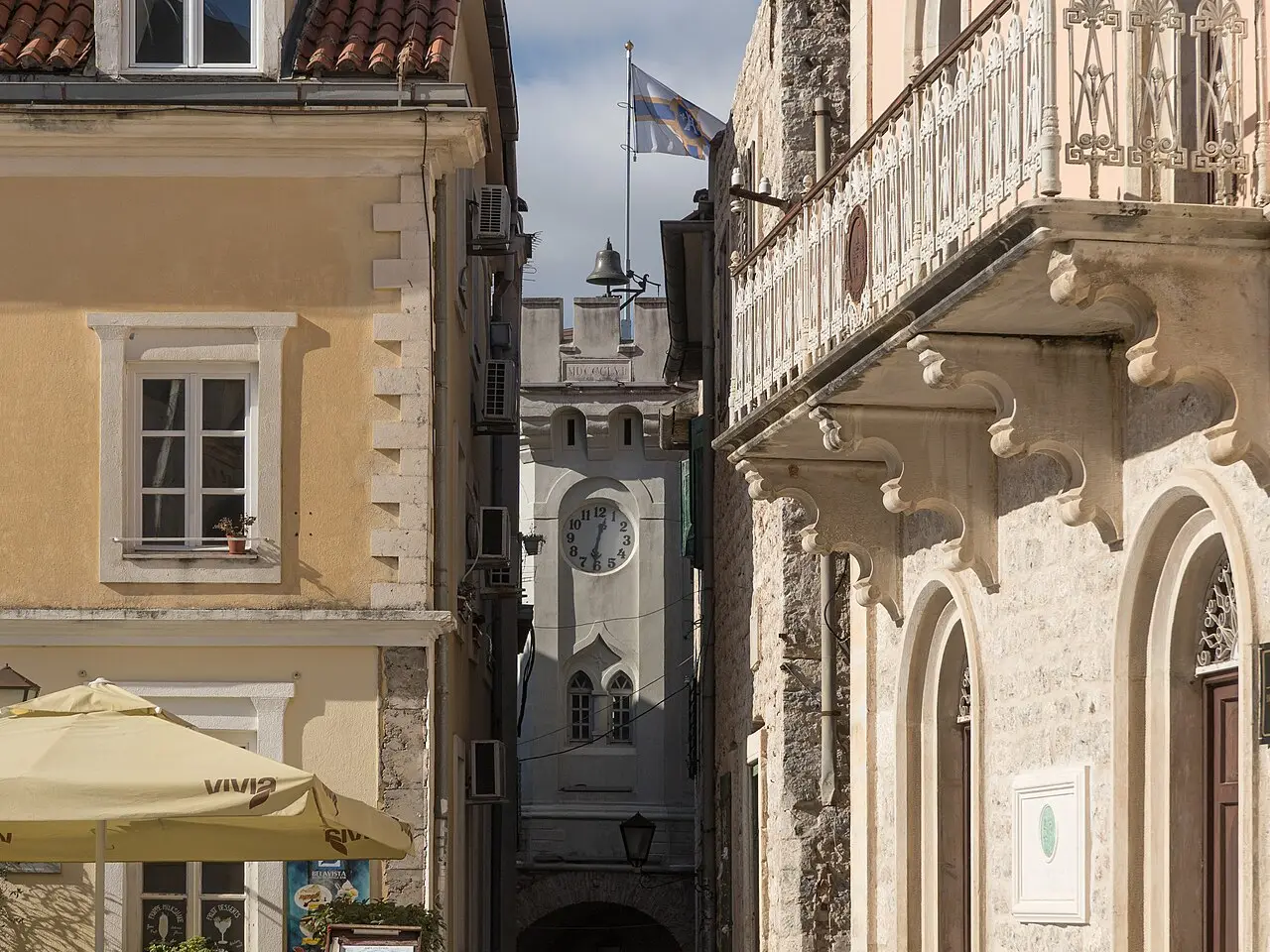 Belavista Square in Herceg Novi Old Town with stone paving, cafés and a domed church