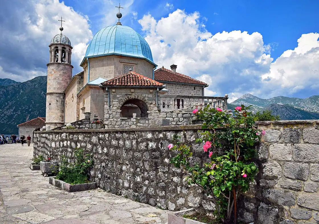 Close view of the blue-domed church on Our Lady of the Rocks island near Perast