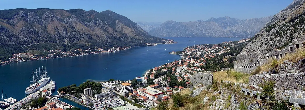 Wide panorama of Kotor, its old town and the blue Bay of Kotor seen from the city wall
