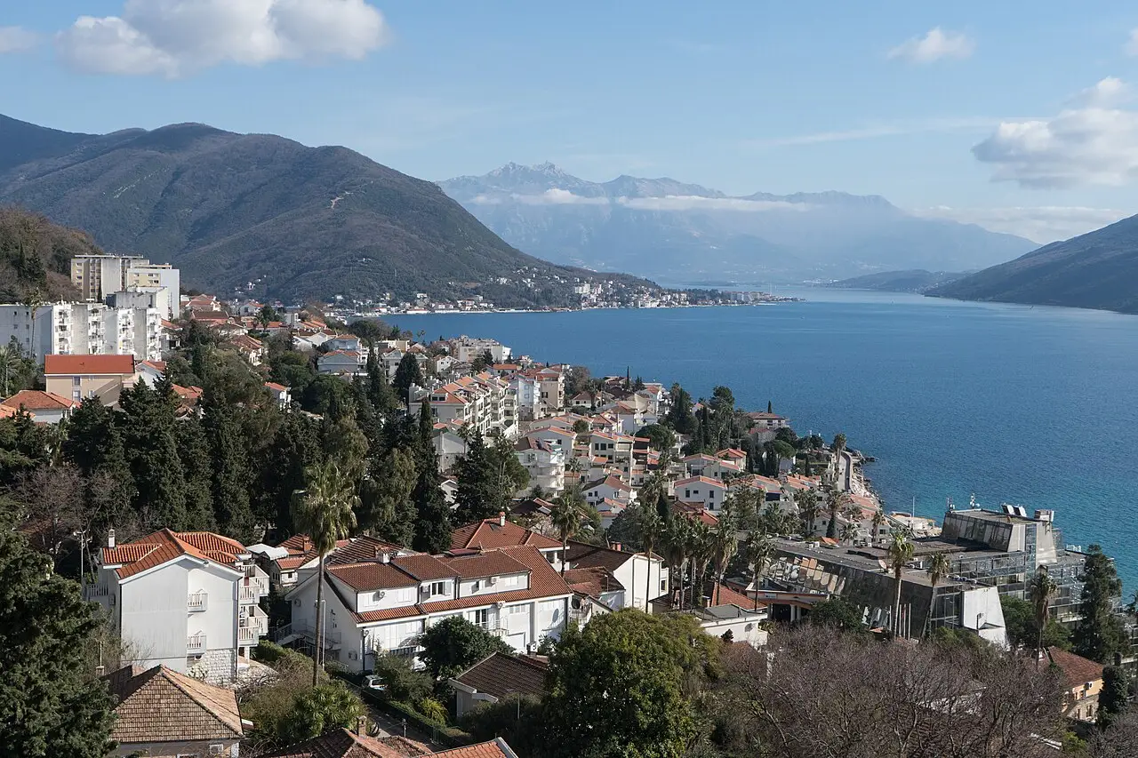 Herceg Novi old town descending to the Bay of Kotor, with mountains across the water