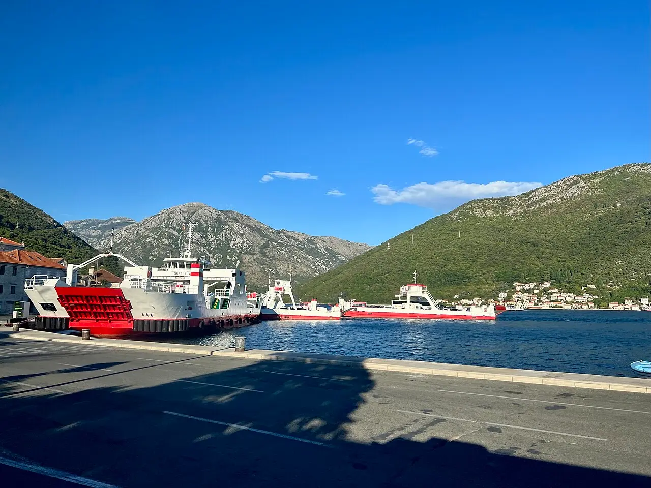 The Kamenari-Lepetane ferries moored on the Bay of Kotor with mountains behind