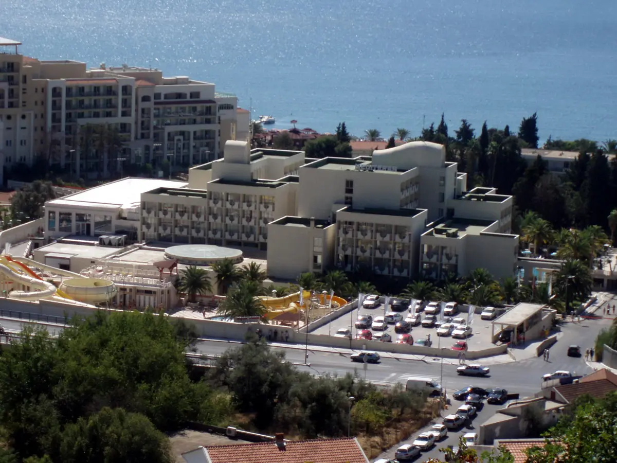 The long resort beach at Becici south of Budva, backed by hotels and mountains
