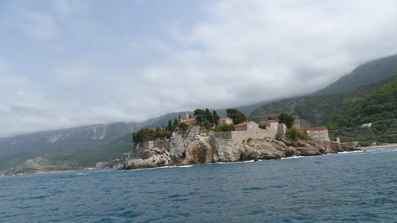 The fortified islet of Sveti Stefan and its pink-pebble beaches on the Budva Riviera, Montenegro