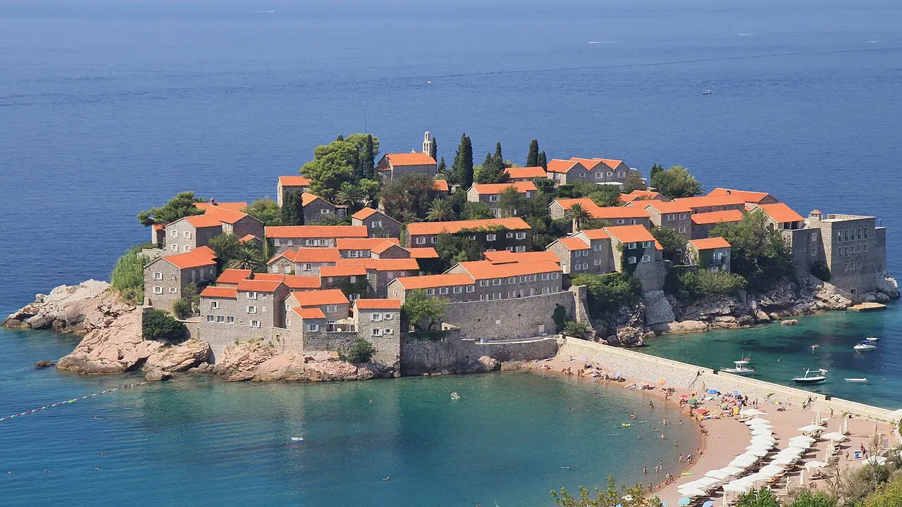 The red-roofed islet of Sveti Stefan filling the frame above its turquoise bay