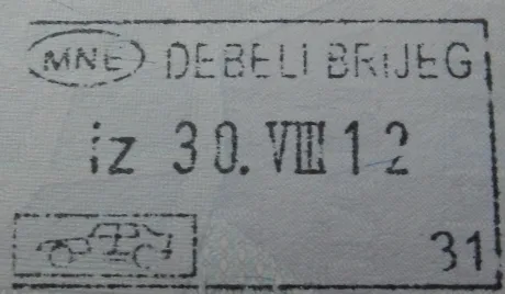 A Montenegrin exit stamp from the Debeli Brijeg border crossing in a passport