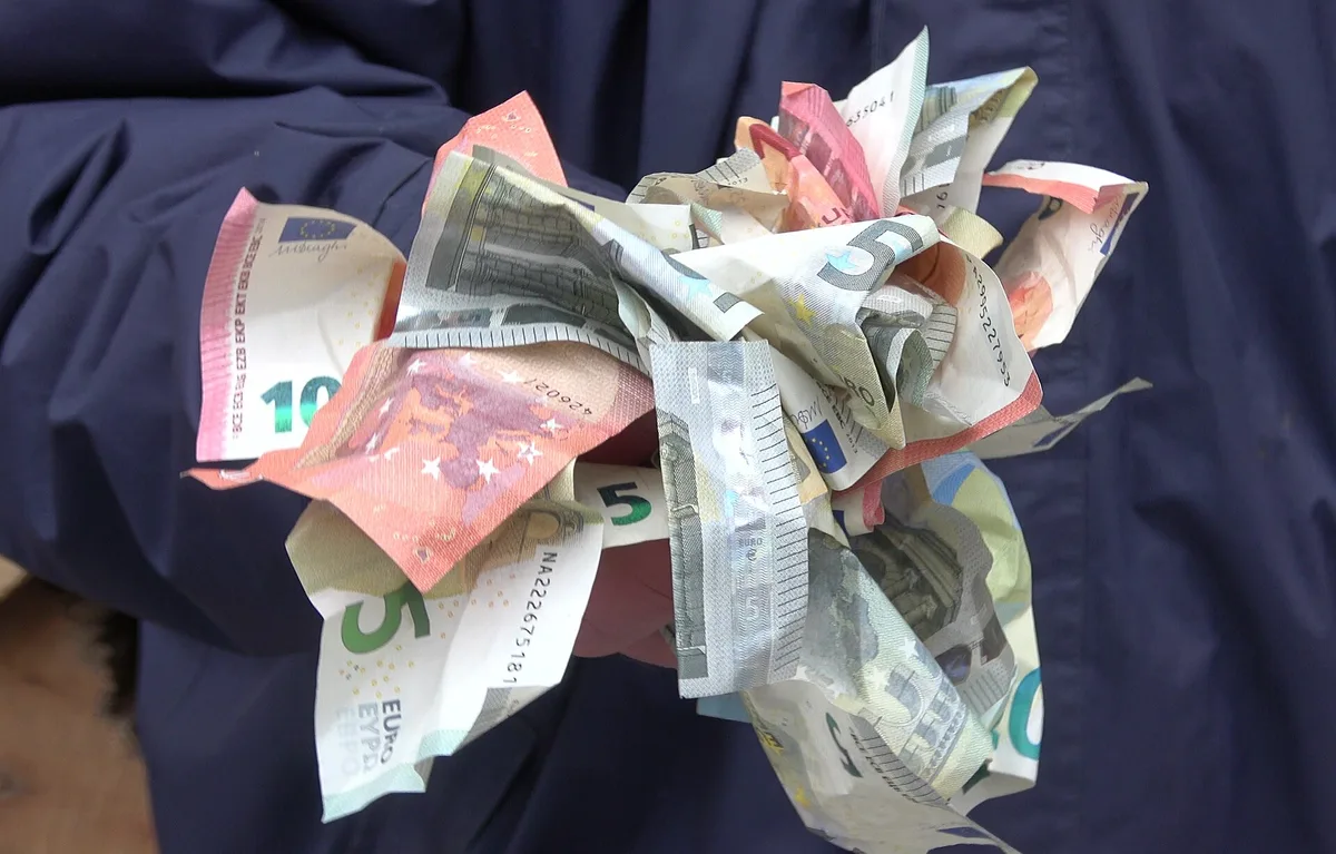 A handful of folded euro banknotes, the everyday currency of Montenegro