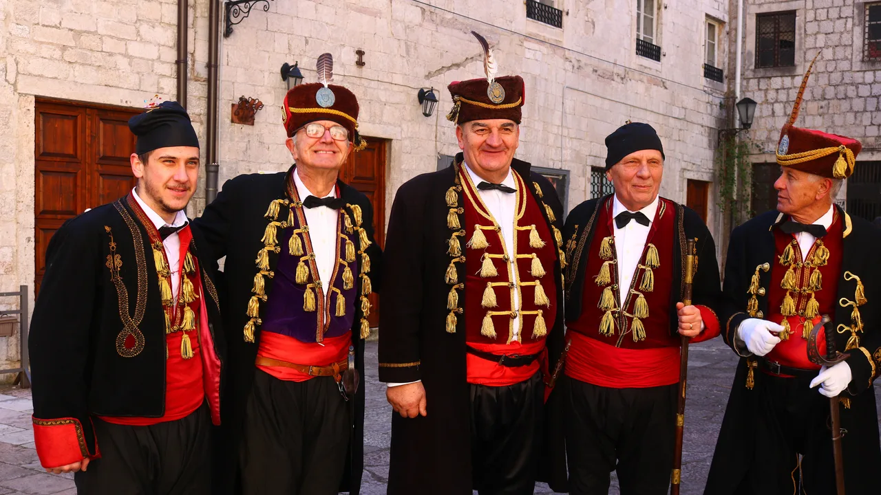 Men of the Boka Navy in traditional red and gold uniforms in Kotor old town during the St Tryphon celebrations