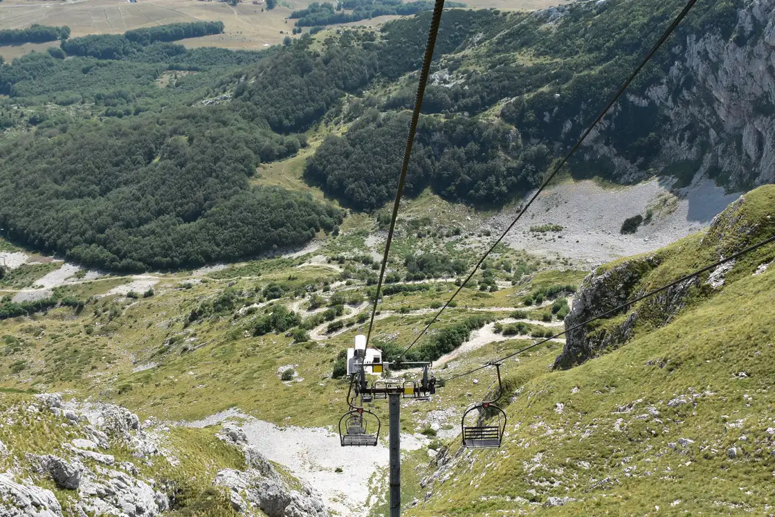 The Savin Kuk chairlift line running down the mountainside above Zabljak, empty chairs on the cable